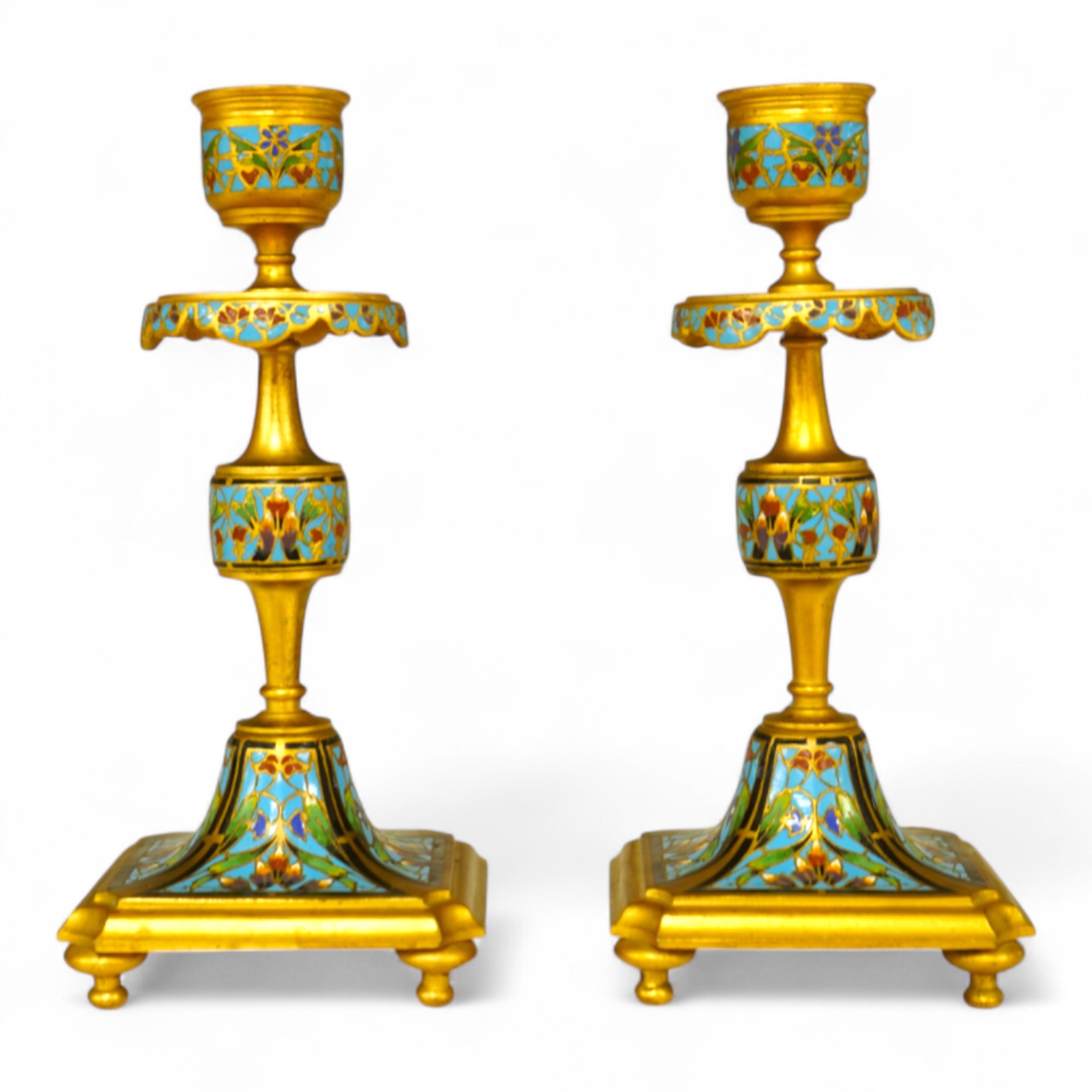 A pair of late 19th century French champleve enamel and ormolu candlesticks, 17cm
